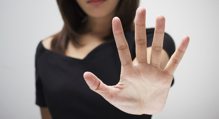 Young Woman Showing Her Denial With No On Her Hand